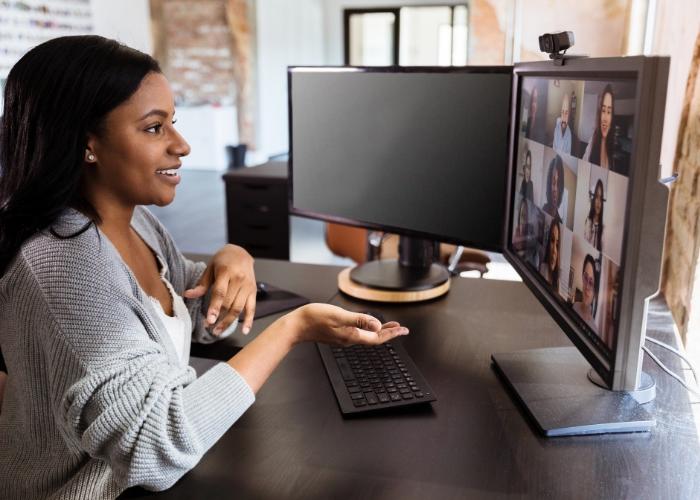 Woman at desk talking in a group video call.